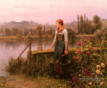 Une femme avec un arrosoir par la paysanne rivière Daniel Ridgway Knight Peinture à l'huile